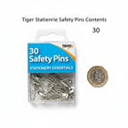 Tiger Stationery 30 assorted safety pins flat lay with clear storage box and £1 coin for scale — clean white background