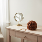 Warm auburn copper curly messy hair bun shade 33/30 Sunrose on a dressing table vanity with natural window light, interior magazine styling
