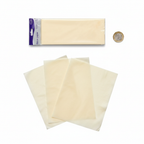 Ivory tissue paper pack of 10 placed beside a £1 coin on white background to show size, overhead flat lay product photography