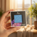 Hand holding Lilyz Eyeshadow Mono Electric Blue in a natural beauty setting
