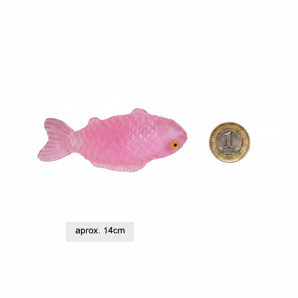 Pink squishy sticky fish toy placed beside a £1 coin on white background to show product size approximately 14cm