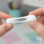 Extreme macro close-up of white adhesive putty tack showing soft pliable texture and clean white colour