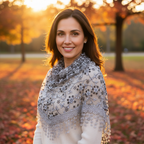 Woman wearing grey triangle lace scarf on an autumn walk at golden hour, scarf draped elegantly over shoulders