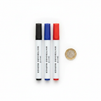 Swift Assorted Colour Whiteboard Markers 3 Pack flat lay with £1 coin for scale showing all three markers with black, blue and red caps