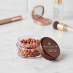 Body Collection Bronzing Pearls on elegant vanity with marble surface and natural lighting