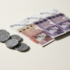 Extreme macro close-up of Sterling Play Money banknotes and coins showing fine print detail and coin relief texture