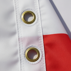 Close-up of reinforced brass eyelets on England St George Cross flag showing quality stitching and durability
