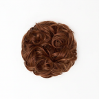 Extreme macro close-up of warm auburn copper curly hair bun 33/30 Sunrose showing individual curl texture, cinnamon copper russet tones and strand craftsmanship