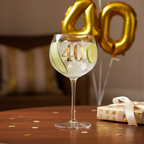 Art Deco 40th Birthday Gin Glass styled on a birthday gift table with gold balloons and celebration decorations, outcome lifestyle shot