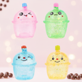 All four Stretch and Squeeze Bubble Tea Gel Toy colours in 2x2 grid on pastel bubble tea cafe background with scattered pearls