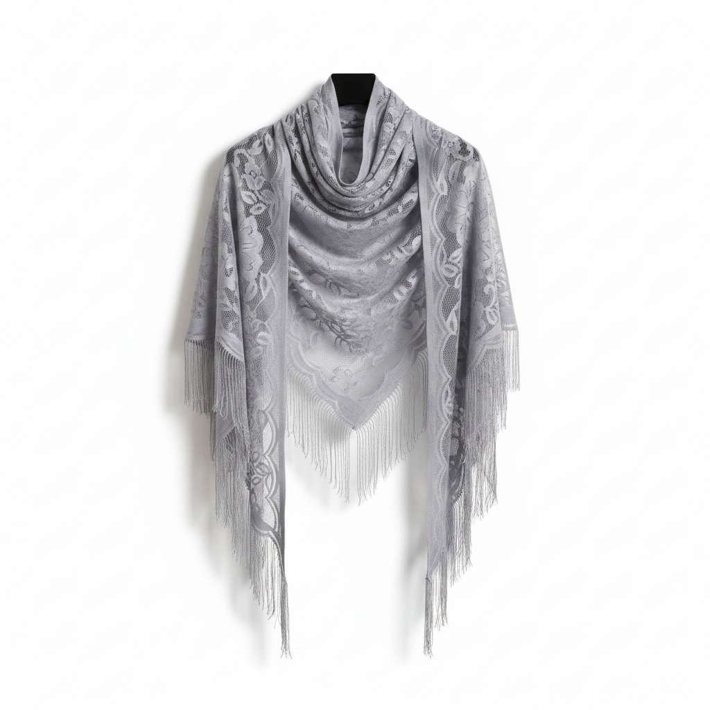 Silver grey sheer lace triangle shawl with floral embroidery and long tassel fringe elegantly draped on white background, studio product shot