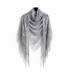 Silver grey sheer lace triangle shawl with floral embroidery and long tassel fringe elegantly draped on white background, studio product shot