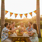 Flamingo Hawaiian Party Bunting 6m strung across a garden party with friends celebrating at golden hour