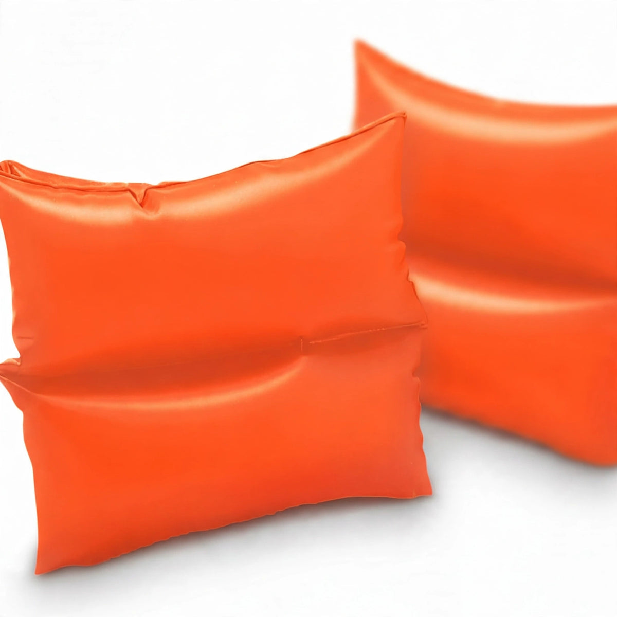 Close-up view of bright orange Intex inflatable swimming arm bands made from PVC