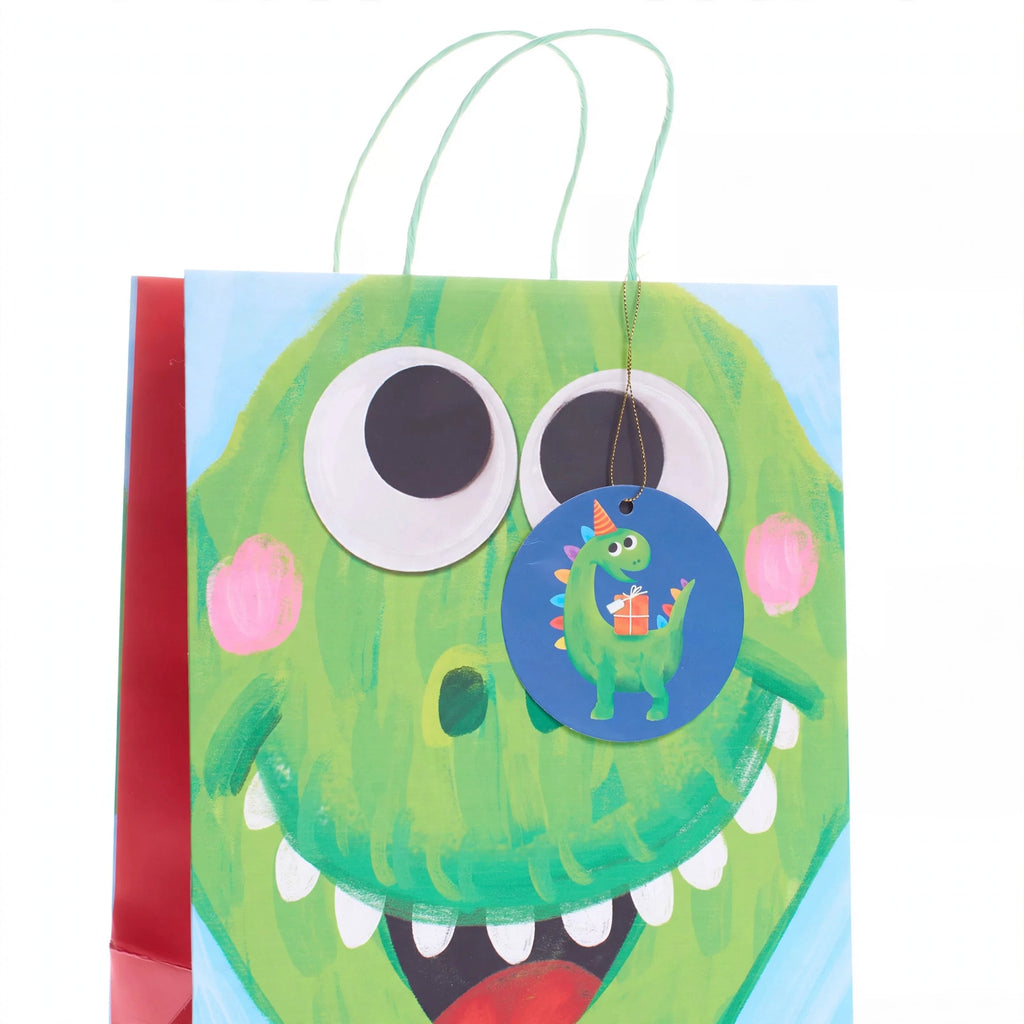 Close-up of multi-coloured dinosaur print on medium kids gift bag