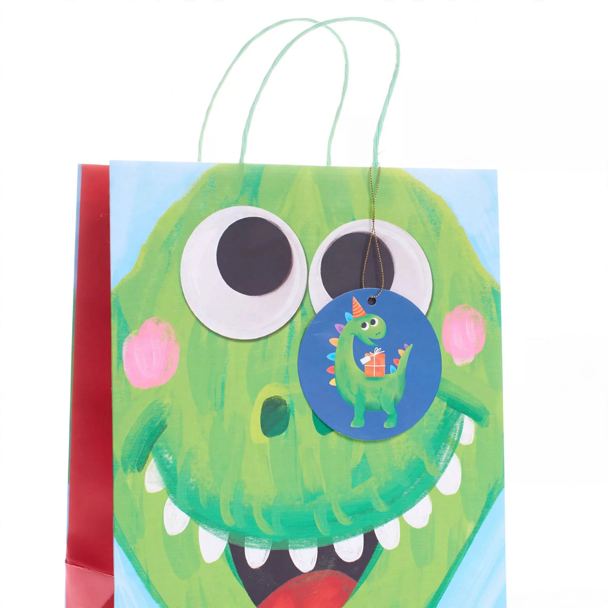 Close-up of multi-coloured dinosaur print on medium kids gift bag