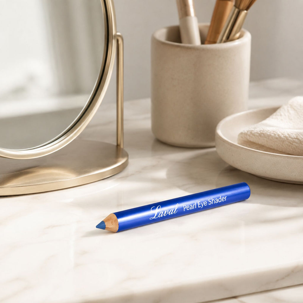 Laval Ocean Blue eyeshadow pencil displayed on a neutral dressing table beside a mirror