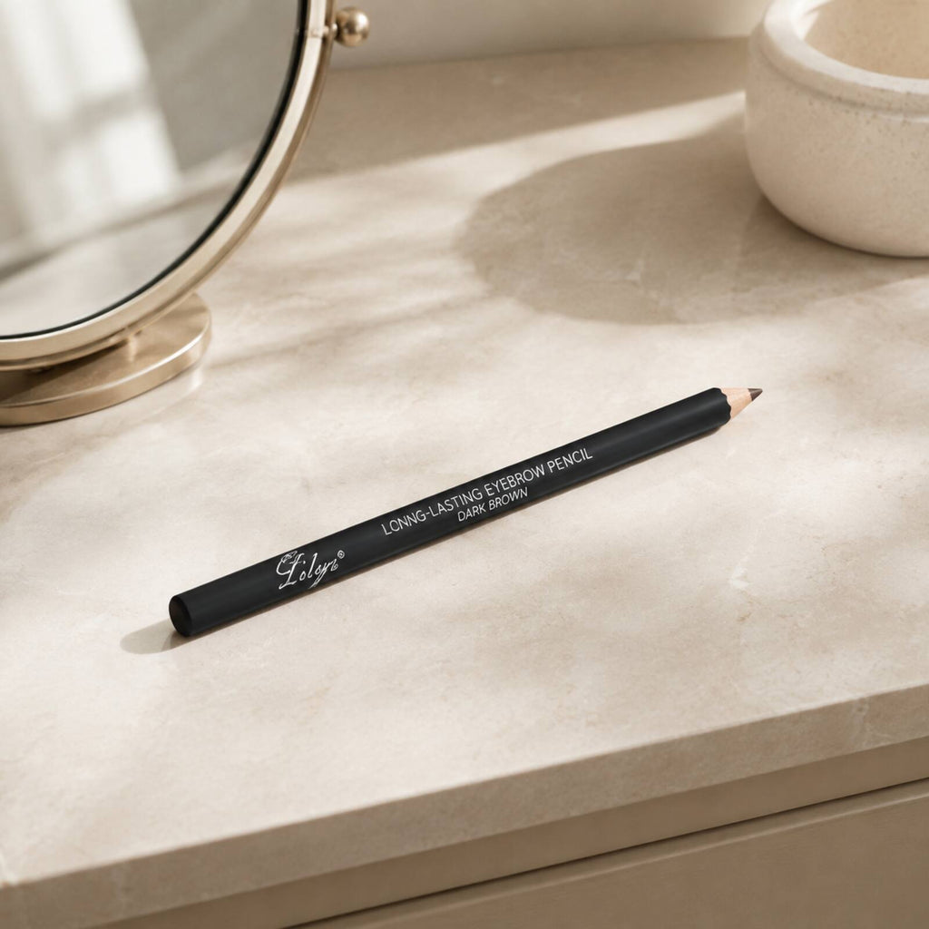 Lilyz Dark Brown eyebrow pencil displayed on a neutral dressing table beside a mirror