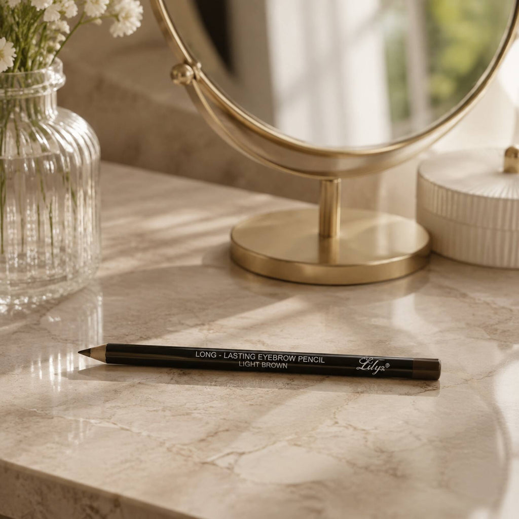 Lilyz Light Brown eyebrow pencil displayed on a warm neutral dressing table beside a mirror