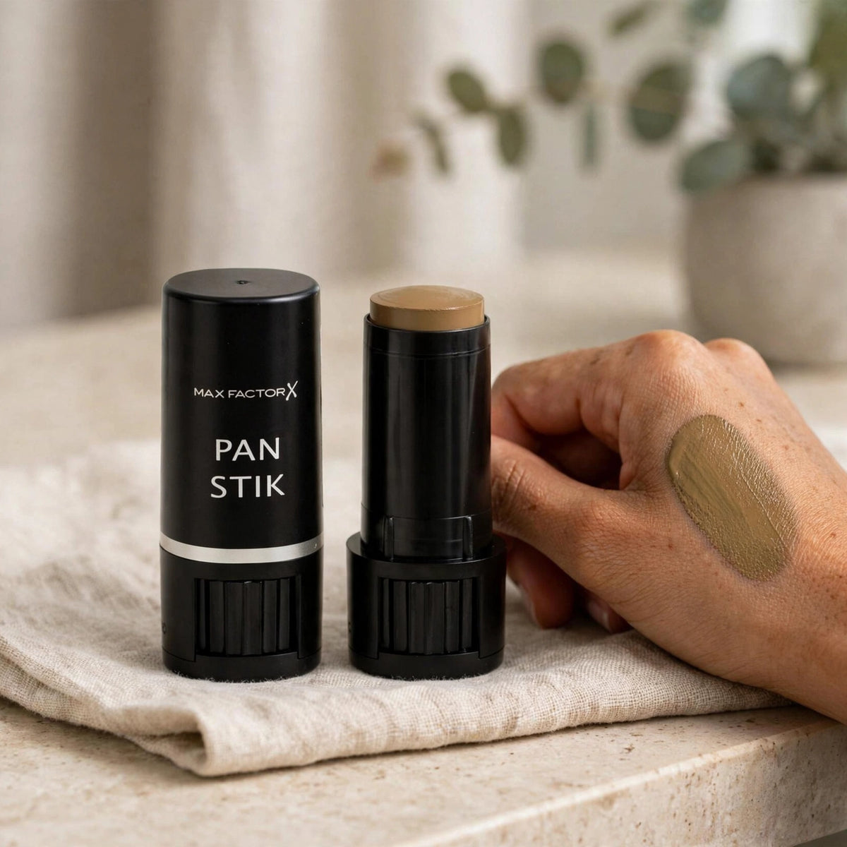 Max Factor Pan Stik foundation stick in Deep Olive Shade 60 displayed for makeup use