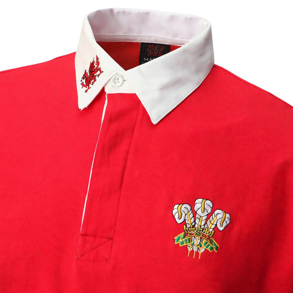 Close-up of the three feathers emblem and button placket on the Welsh rugby shirt