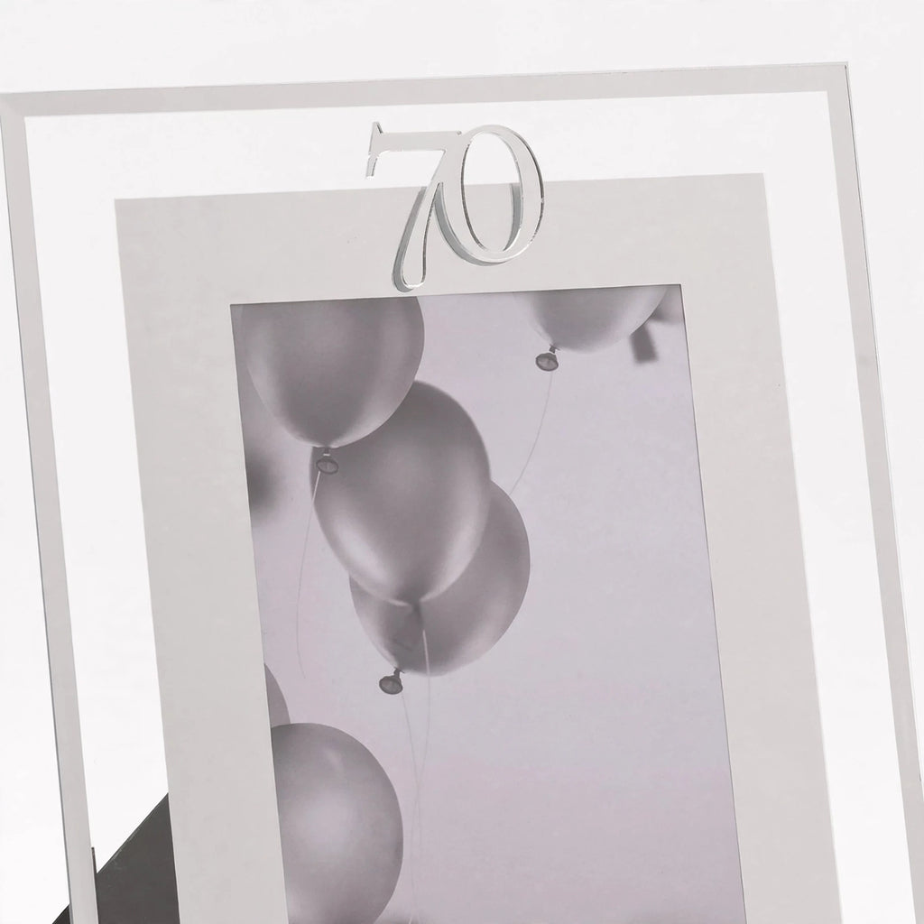 Close-up view of silver photo frame with 70th birthday inscription