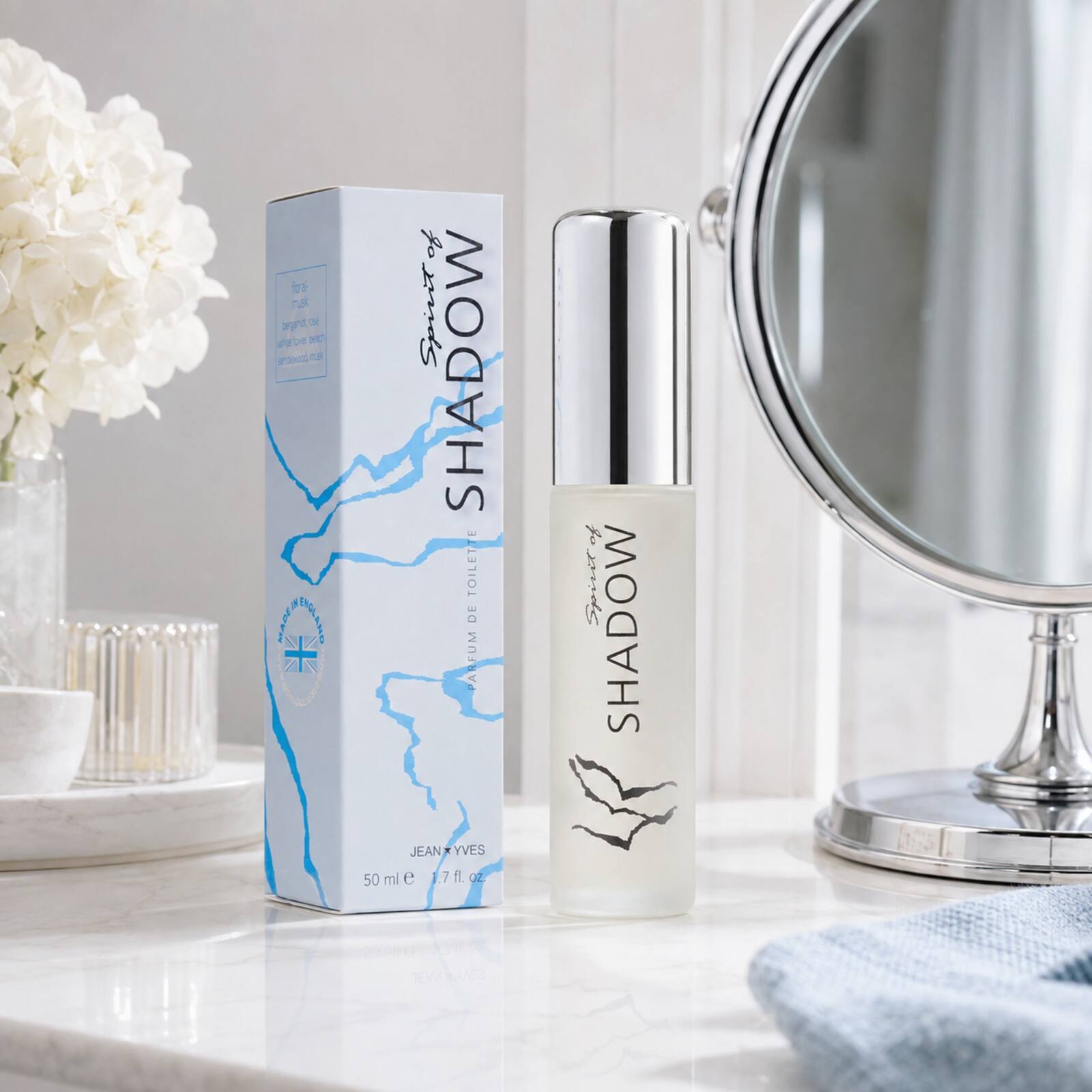 Spirit of Shadow 50ml bottle and pale-blue box displayed beside a vanity mirror