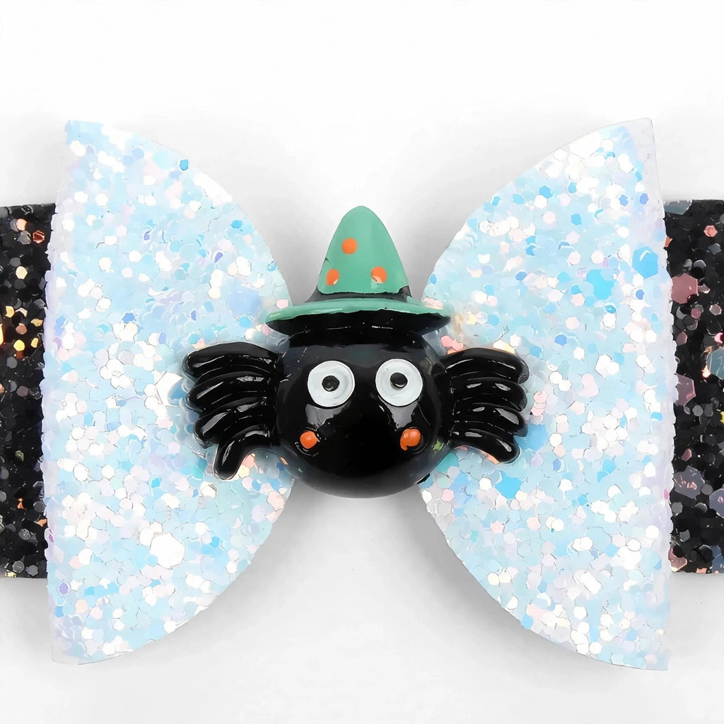Close-up view of Mischief spider bowknot hair clip with glitter finish