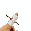 Nail Through Finger Joke prop with realistic nail-through-finger appearance