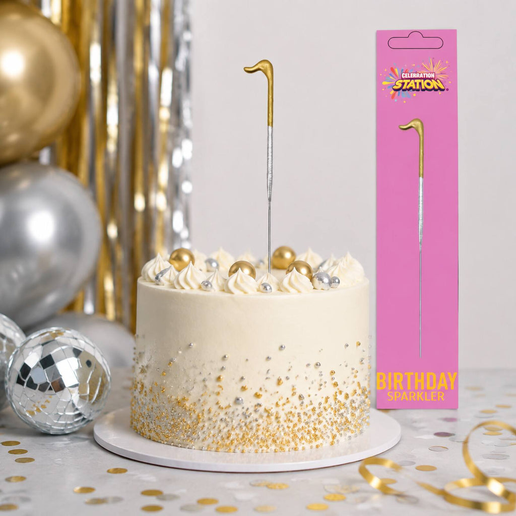 Unlit gold number 1 birthday sparkler in a silver and gold party display