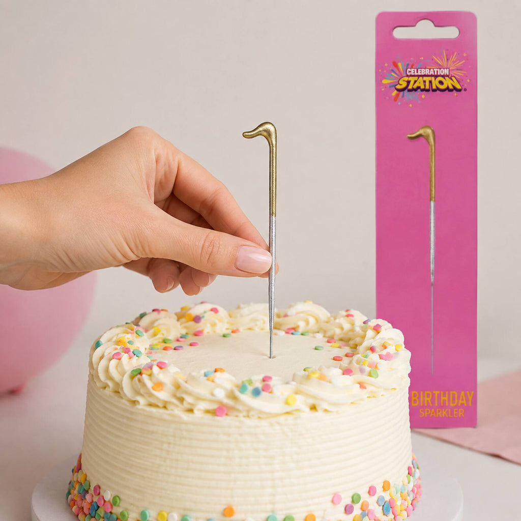 Adult safely placing an unlit number 1 birthday sparkler into a cake