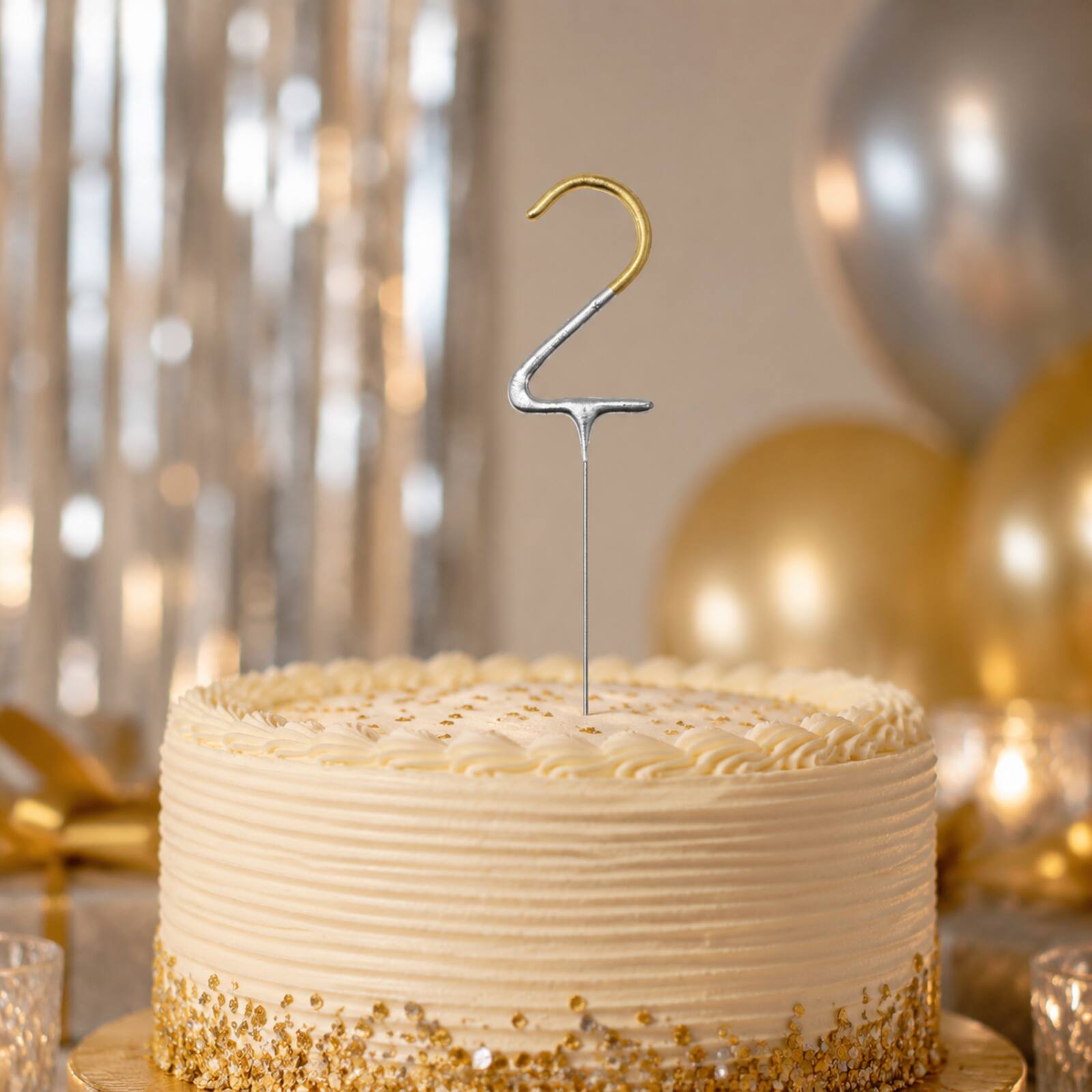 Unlit gold number 2 sparkler displayed in a second-birthday cake