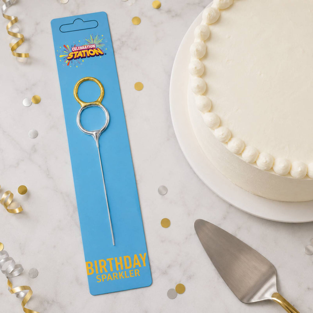 Packaged number 8 birthday sparkler beside a celebration cake and cake server
