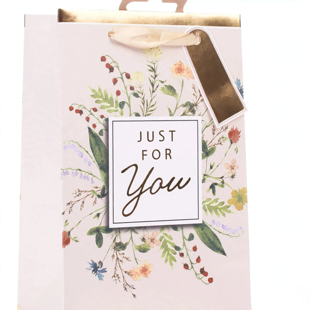 Close-up view of gift bag with multi-coloured flowers design