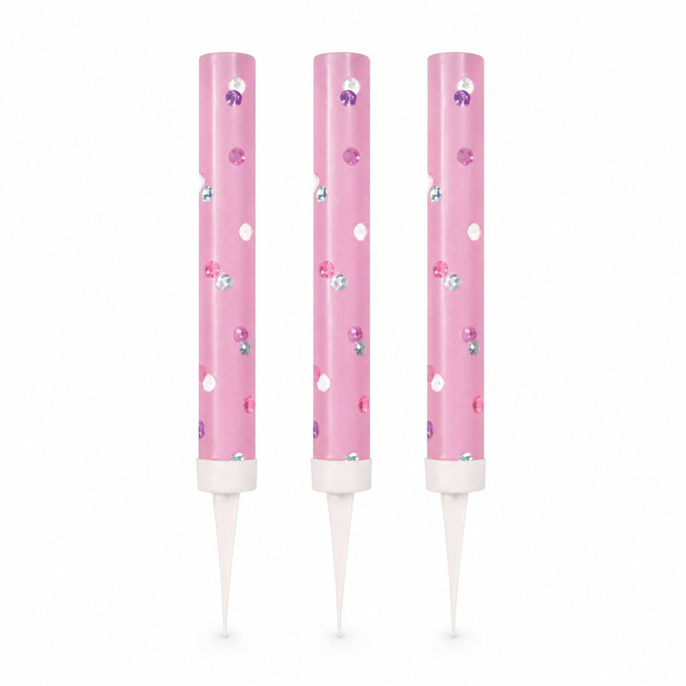 Three pink glitz ice fountain cake decorations with reflective dots on white