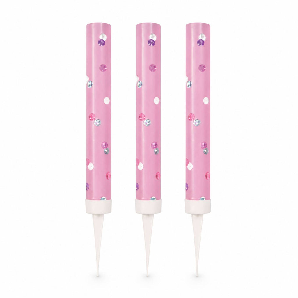 Three pink glitz ice fountain cake decorations with reflective dots on white