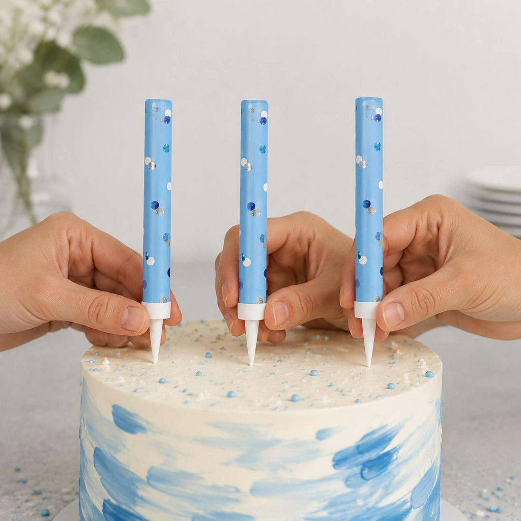 Adult safely placing three unlit blue cake fountains into a cake