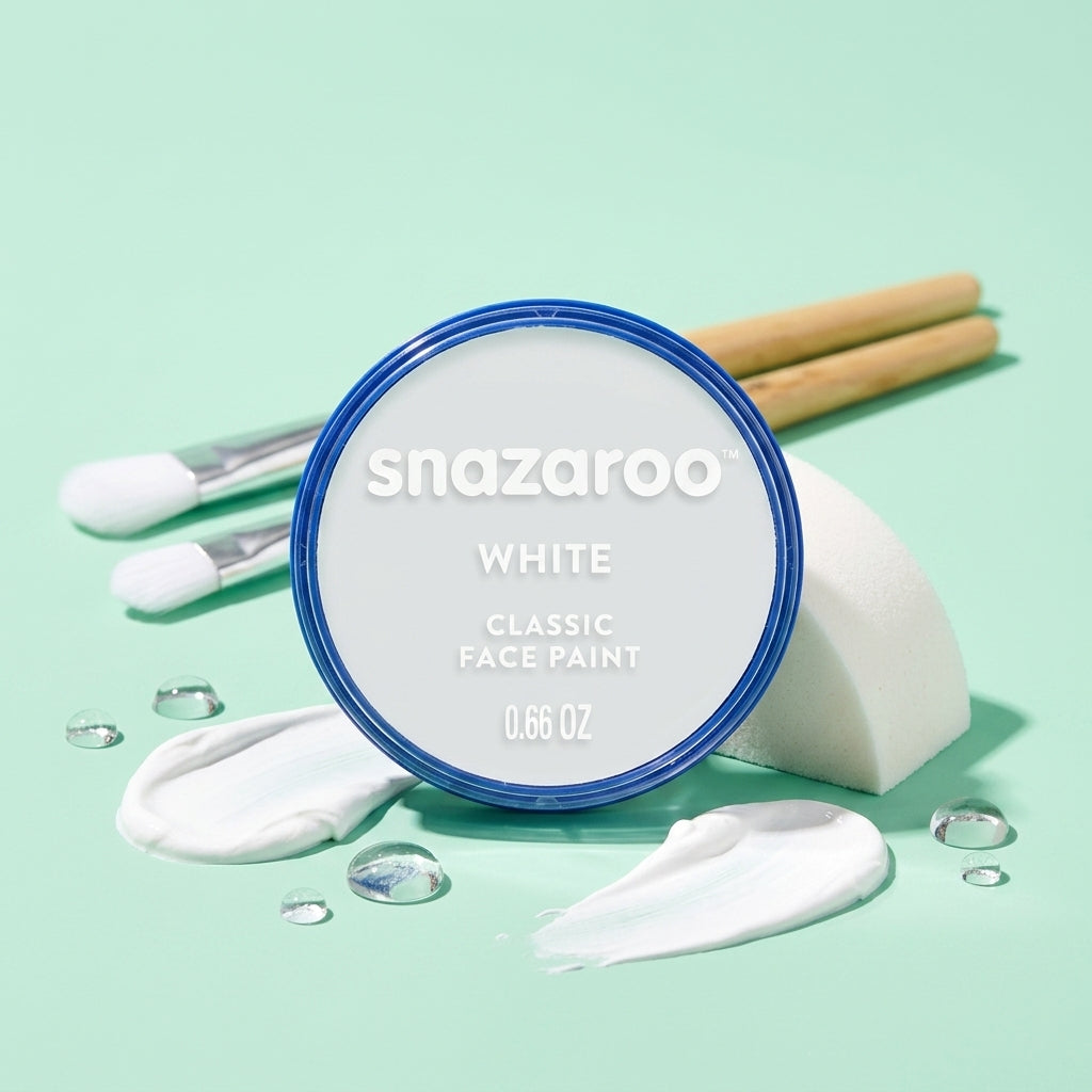 A round tin of Snazaroo Classic Face Paint in the shade White, styled with makeup sponges, white cream, and makeup brushes on a mint green background.