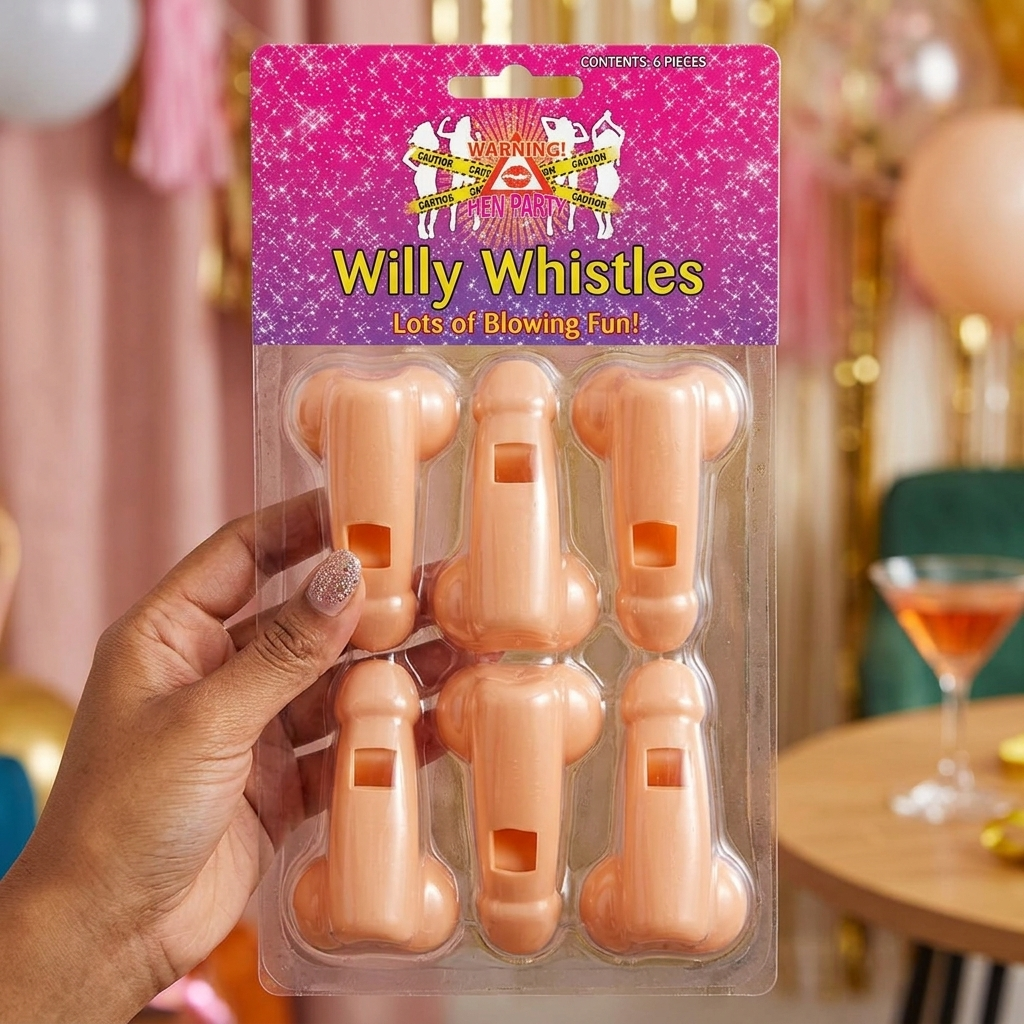 A hand holds a blister pack of six novelty plastic whistles shaped like male genitalia. The packaging has a bright pink header card with the text 'Willy Whistles' and 'Lots of Blowing Fun!'.