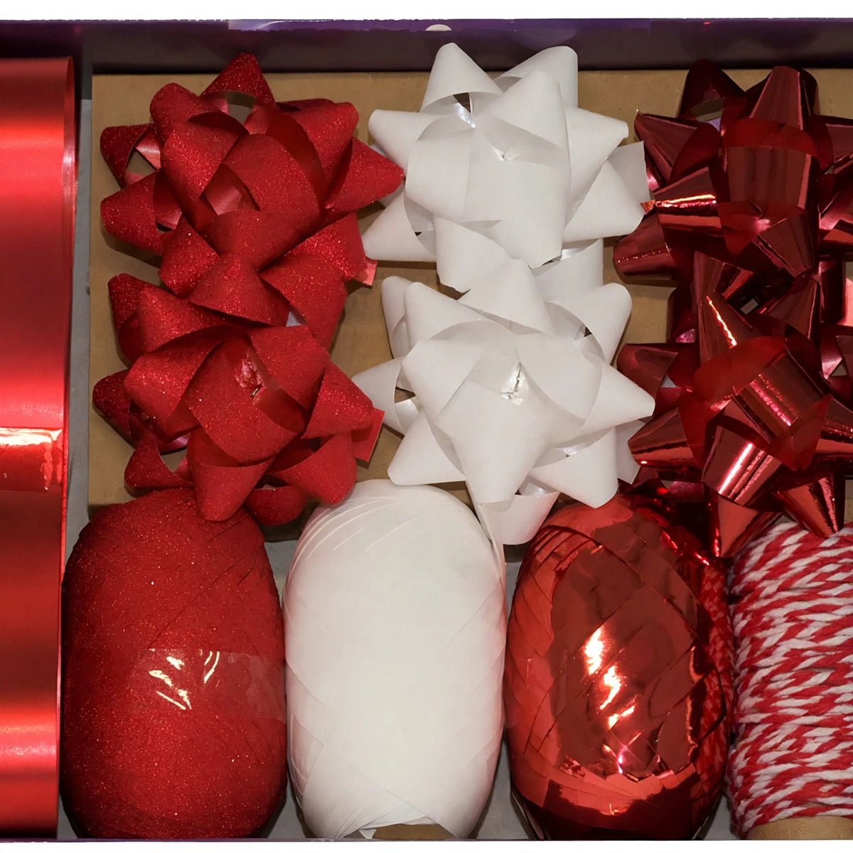 Close-up view of red and white decorative bow and ribbon from gift wrapping set