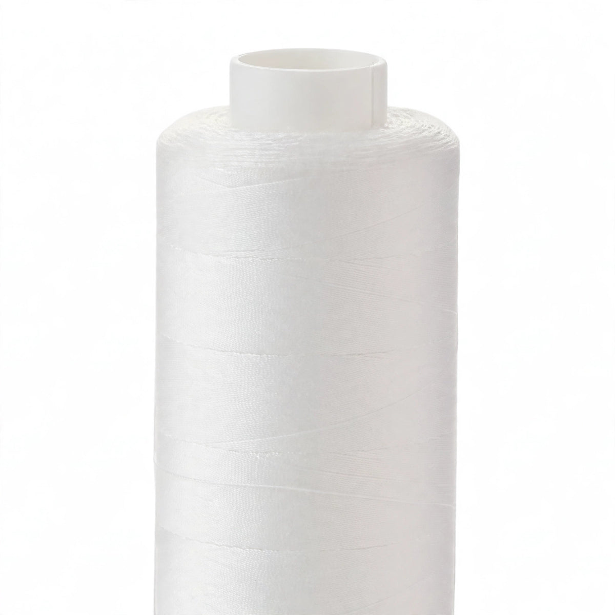Close-up view of white cotton sewing thread reel