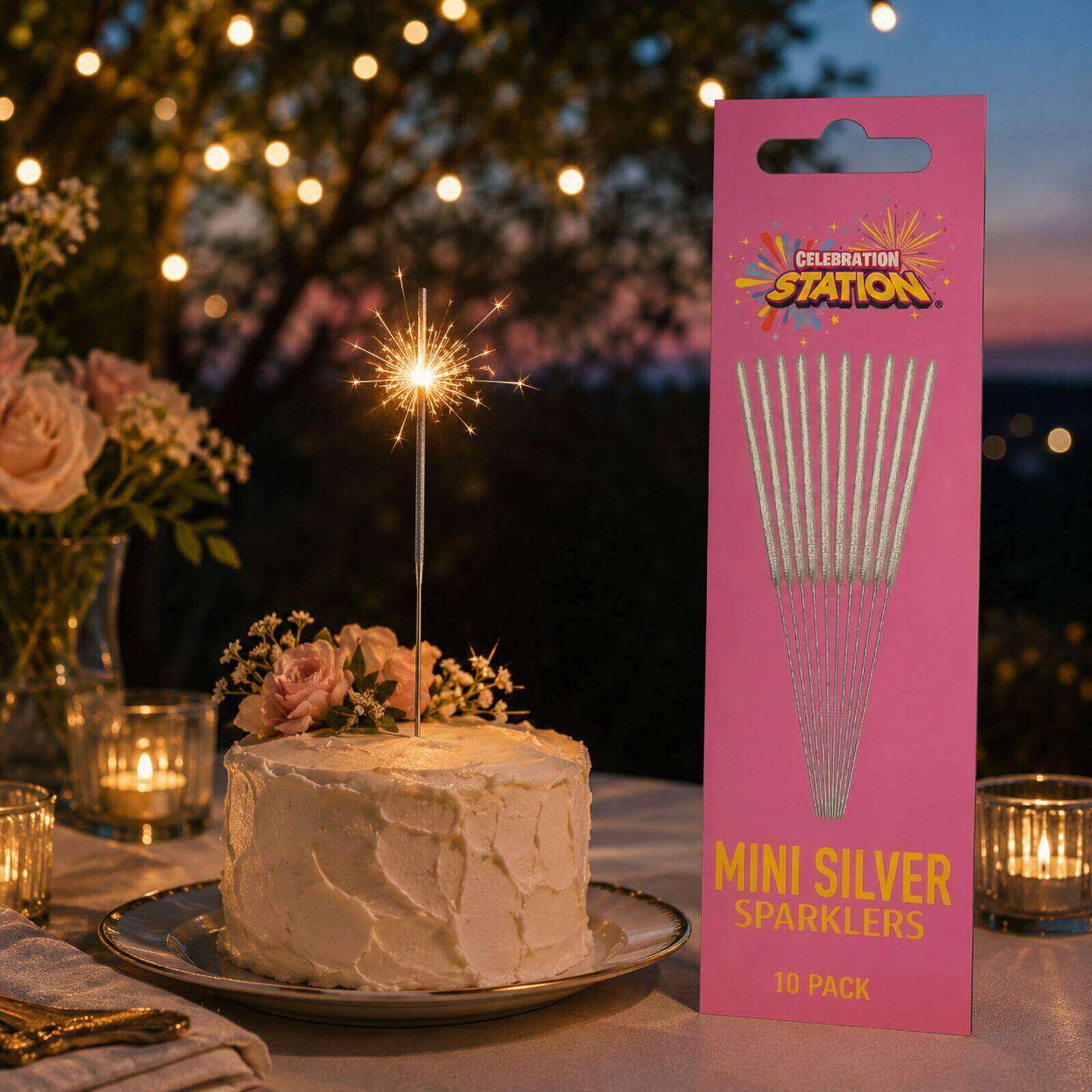 Mini silver sparkler lit on an outdoor birthday cake at dusk