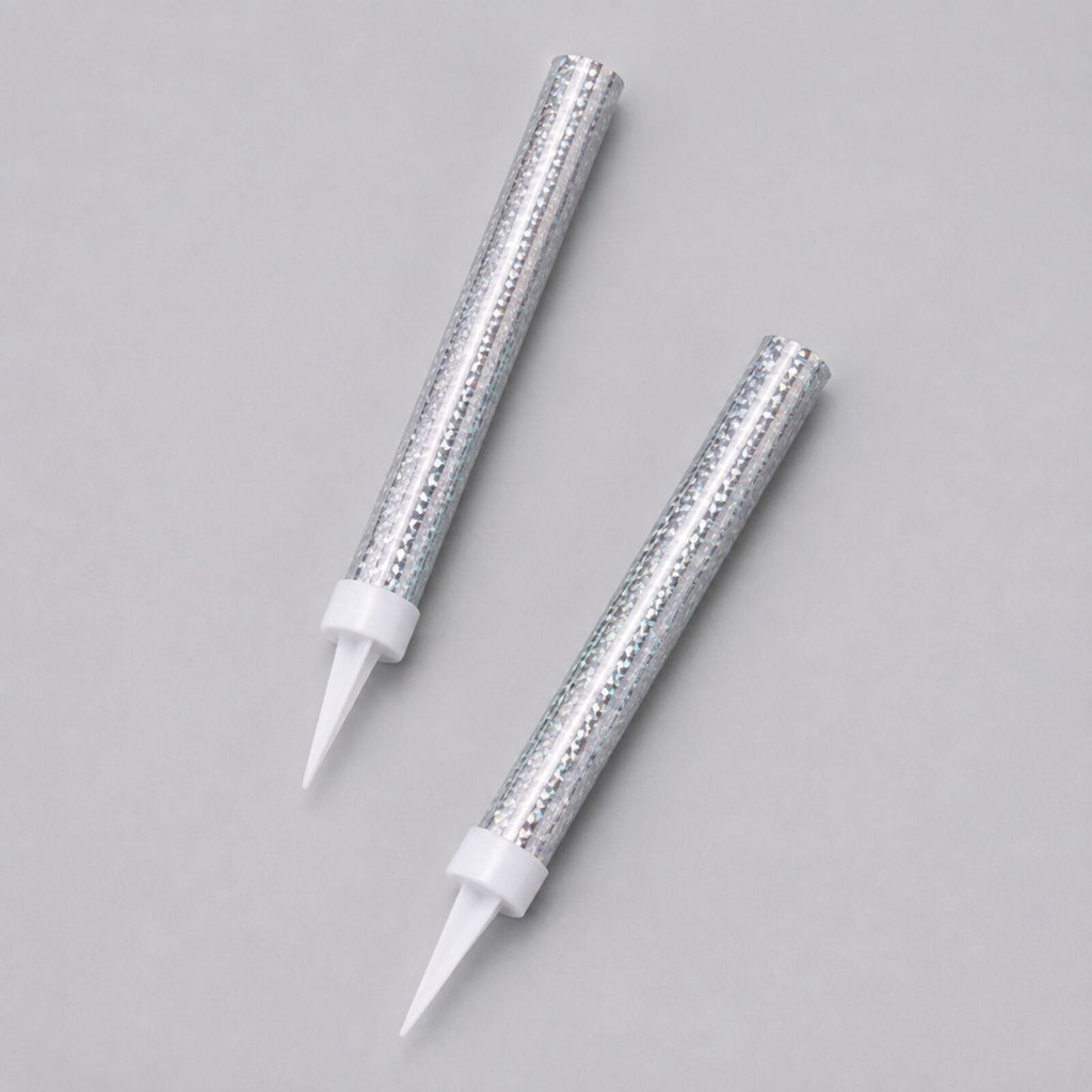 Two silver prismatic ice fountain cake decorations showing foil finish and white spikes