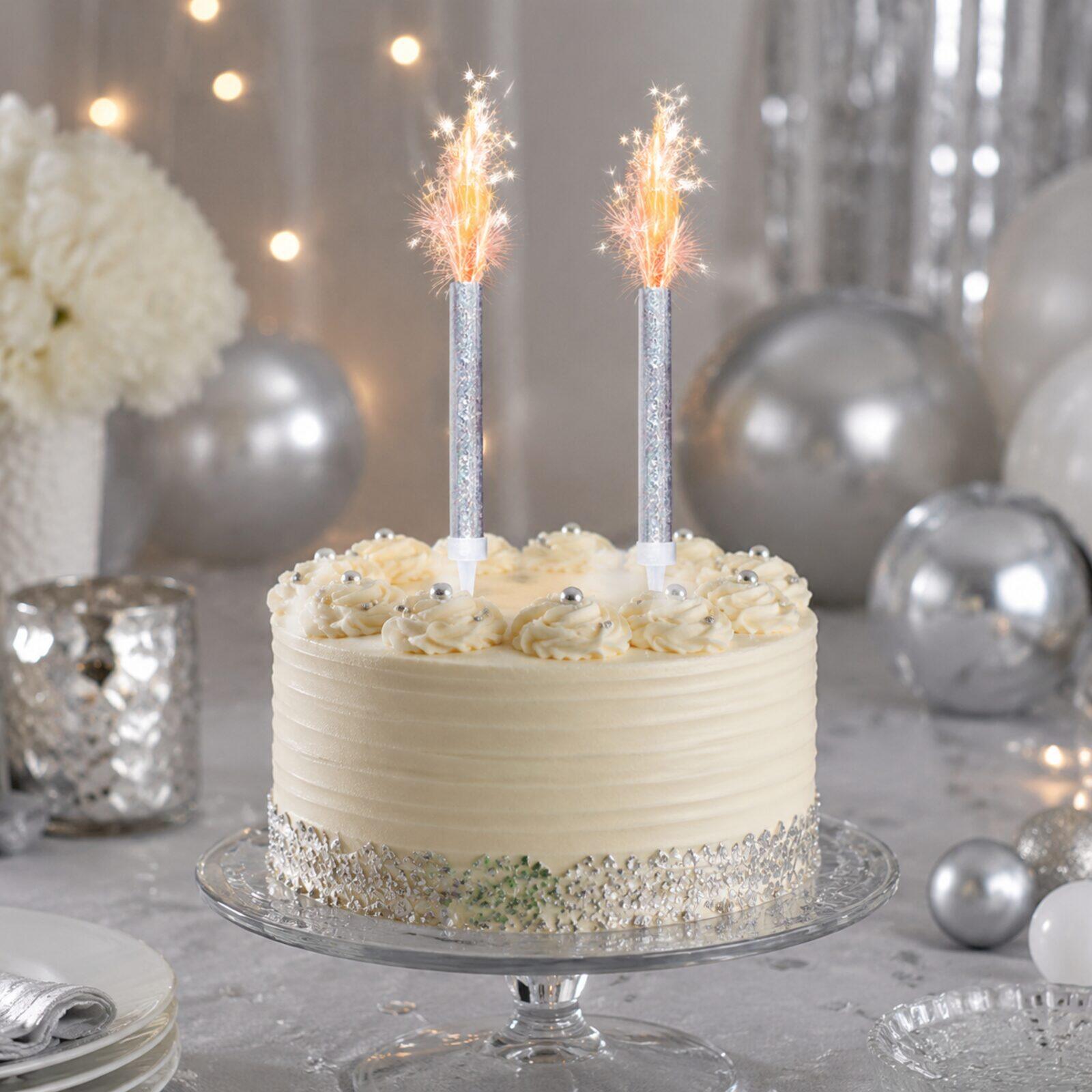 Silver celebration cake display with two sparkling ice fountain decorations