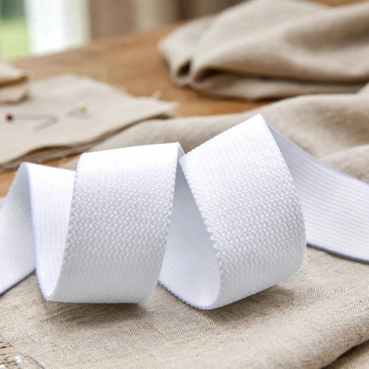 Soft white elastic used in sewing projects for waistbands and cuffs