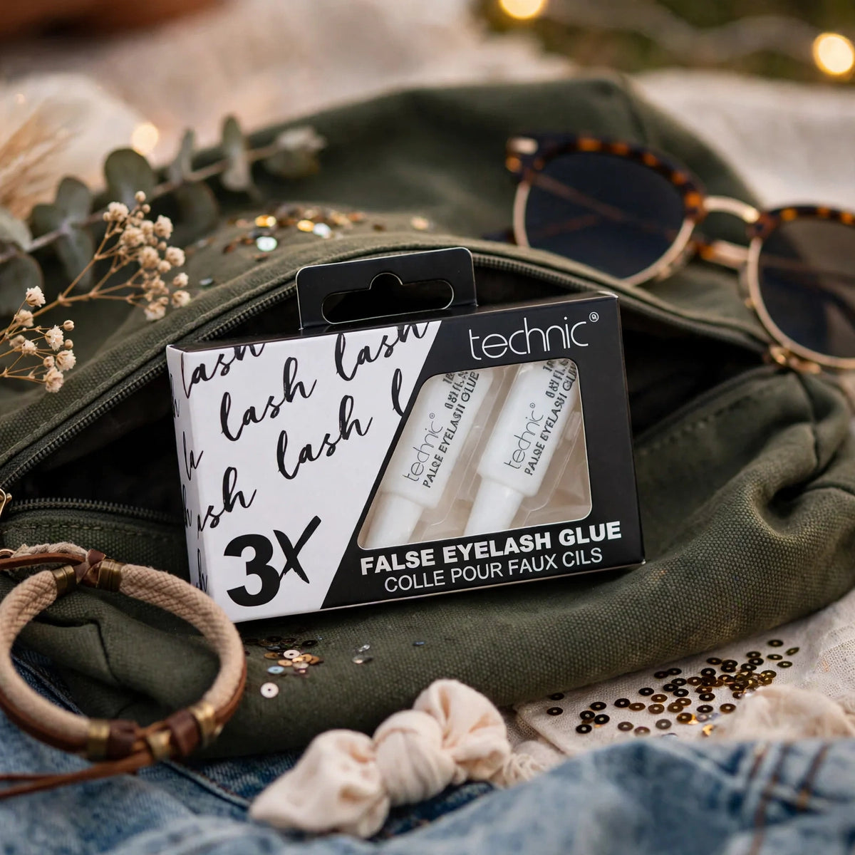 Technic Eyelash Glue tubes shown alongside makeup bag for on-the-go lash touch-ups