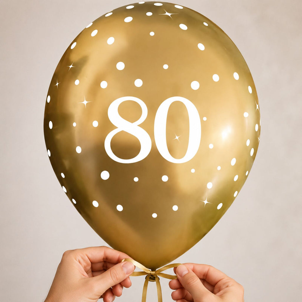 Adult hands safely tying a gold number 80 birthday balloon