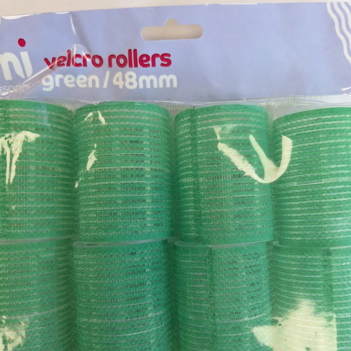 Close-up view of a green Velcro hair roller sized 48mm
