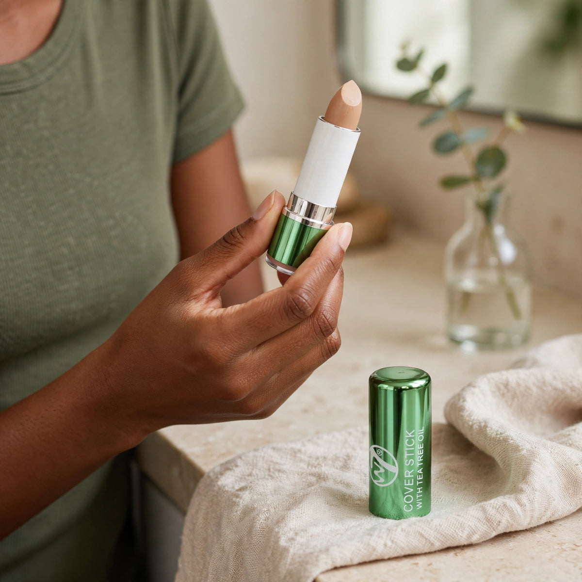 W7 Tea Tree Concealer Stick displayed for makeup use on medium to deep skin tones