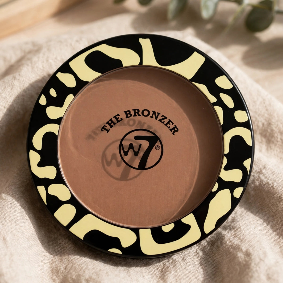 W7 The Bronzer Matte Bronzing Powder Compact shown in makeup bag for on-the-go touch-ups